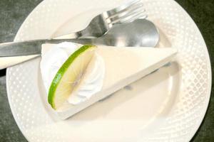 Top view Thai style lime cream cake on white ceramic plate on vintage tone colors. photo