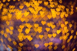 Abstract many yellow heart bokeh background for christmas or happy new year and valentine's day light festival. Soft focus photo