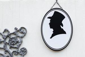 Toilet sign in vintage or classic style gentleman or man symbol on wall WC. photo
