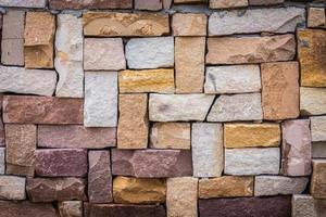 Closeup of multicolored old brick wall background. photo