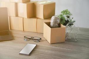 A brown carton is placed on a wooden table. photo