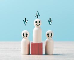 Wooden dolls lined up on a wooden table. photo