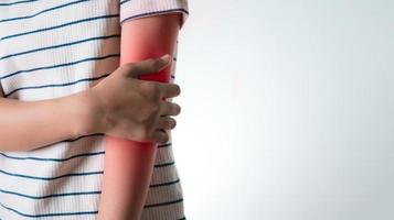 An Asian girl grabs her hand on her elbow. photo