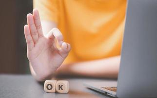 A woman's hand raised to show OK sign photo