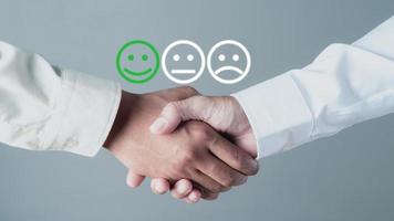 Two young businessmen shaking hands photo