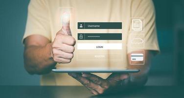 Man holding the tablet in hand and scanning fingerprint to access internet, photo