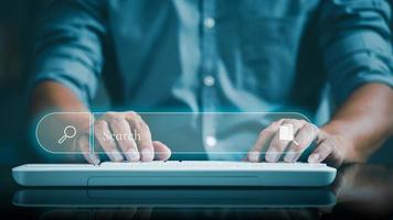 A young businessman is typing a document on a keyboard photo