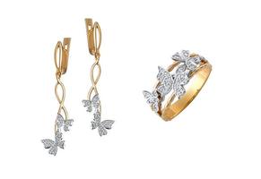 A closeup shot of the gold earrings and ring with diamond butterflies isolated on the white background photo
