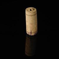 A close-up shot of a wine cork on a reflecting surface. photo