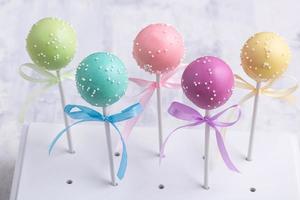 Colorful cake pops on a textured background photo