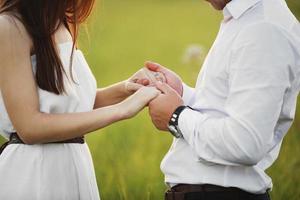 Hands together. Close-up of loving couple holding hands while walking outdoors. man friend husband support woman wife expressing love feelings, trust care honesty in relationship concept photo