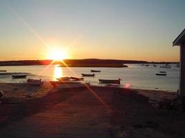 Sunrise in the bay with boats photo