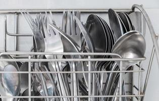 The metal cutlery stands for keeping the silverware near the white wall. photo