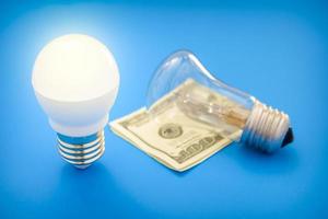 Led light bulb lay next to incandescent bulb photo