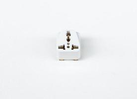 Universal adapter plug on the white canvas. photo