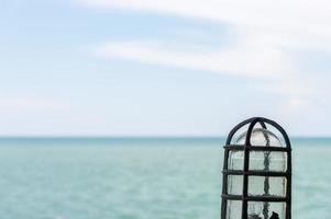 Old vintage lamp with the sea view. photo