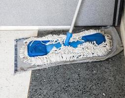 Dirty old mop with the dust. photo