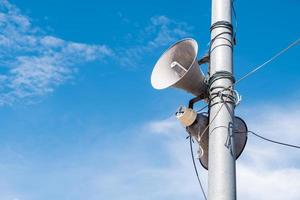 Double megaphone on the metal pole with copy space. photo