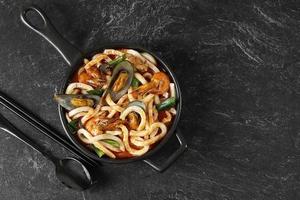 Seafood Udon Noodles or Jjampong, Korean Food Style with Chinese Influence photo