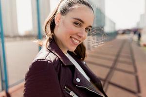 Close up portrait of tenderness woman with wonderful smile posing at camera on sport square background photo