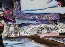 Close up view on samples of cloth and fabrics in different colors found at a fabrics market photo