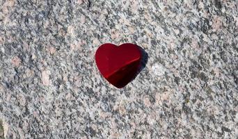 corazón de amor rojo romántico sobre un fondo de granito detallado foto