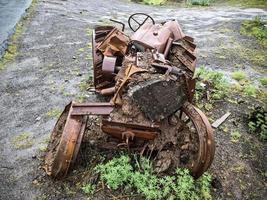 A tractor abandoned a long time ago and completely covered in rust photo