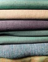 Detailed close up view on samples of cloth and fabrics in different colors found at a fabrics market photo
