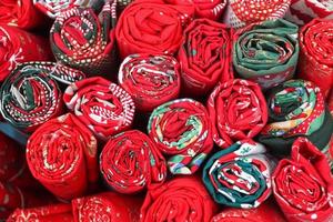 Close up view on samples of cloth and fabrics in different colors found at a fabrics market photo