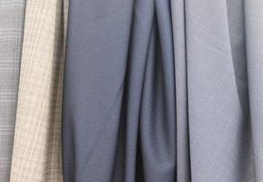 Detailed close up view on samples of cloth and fabrics in different colors found at a fabrics market photo