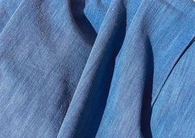 Detailed close up view on samples of cloth and fabrics in different colors found at a fabrics market photo