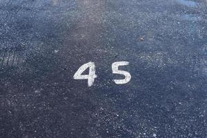 Numbers painted on concrete and asphalt surfaces photo