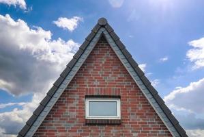 Roof window in velux style with dark roof tiles. photo