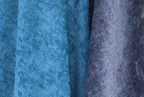 Detailed close up view on samples of cloth and fabrics in different colors found at a fabrics market photo