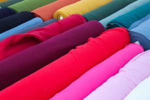 Close up view on samples of cloth and fabrics in different colors found at a fabrics market photo
