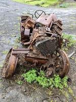 A tractor abandoned a long time ago and completely covered in rust photo