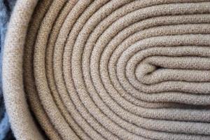 Detailed close up view on samples of cloth and fabrics in different colors found at a fabrics market photo