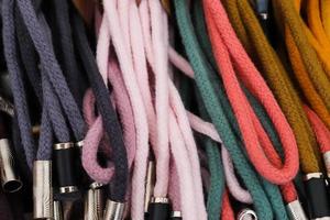 Detailed close up view on samples of cloth and fabrics in different colors found at a fabrics market photo