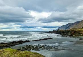 una playa rocosa con témpanos en islandia con fuertes vientos y potente oleaje. foto