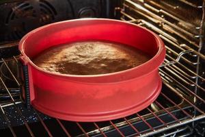 Chocolate cake is baked in the oven in a silicone mold photo