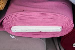 Detailed close up view on samples of cloth and fabrics in different colors found at a fabrics market photo