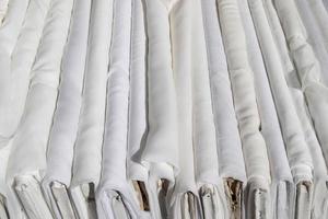 Detailed close up view on samples of cloth and fabrics in different colors found at a fabrics market photo