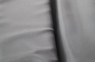 Detailed close up view on samples of cloth and fabrics in different colors found at a fabrics market photo