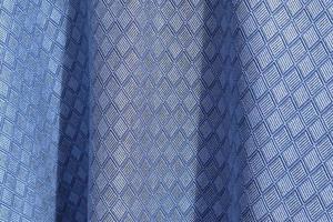 Detailed close up view on samples of cloth and fabrics in different colors found at a fabrics market photo