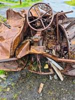 A tractor abandoned a long time ago and completely covered in rust photo