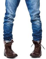 Male legs in jeans and leather boots photo