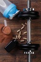 Dumbells and food supplements photo
