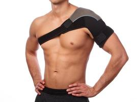 Man with a support bandage on his shoulder photo
