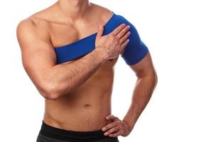 Man with a support bandage on his shoulder photo