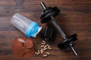 Dumbells and food supplements photo